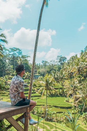 man sitting 0n wooden table