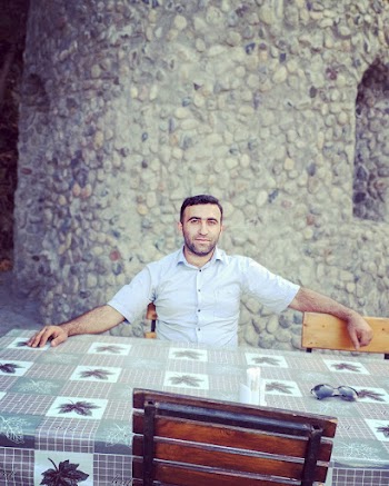 Man Sitting at the Table