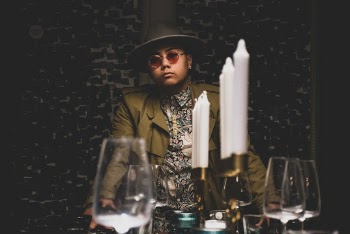 Man Sitting at the Table Wearing Hat and Sunglasses