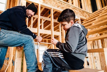 Man Sitting Beside Boy in Stair