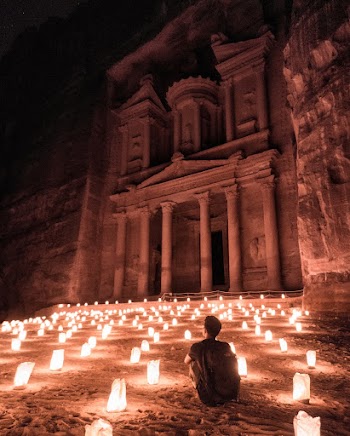 Man Sitting Beside Building