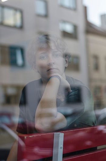 man sitting beside glass window