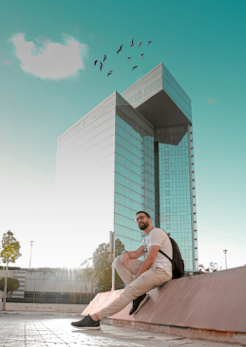 Man Sitting Beside Mirror Building
