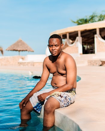 Man Sitting Beside Pool