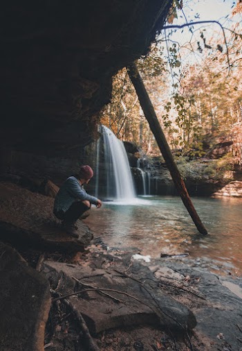 Man Sitting Beside River