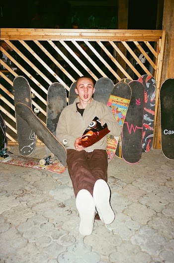 Man Sitting Beside Skateboards