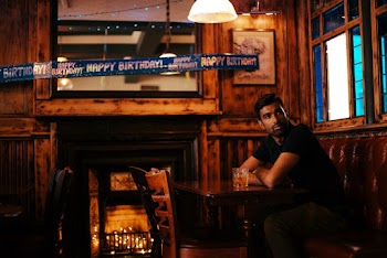 Man Sitting Beside Table