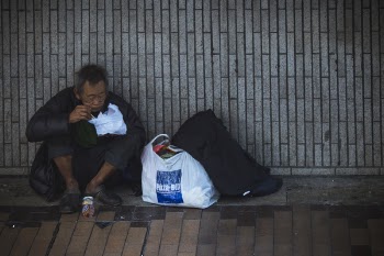 Man Sitting Beside Wall