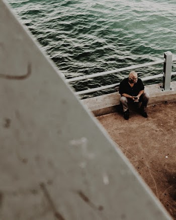 Man Sitting Beside Water