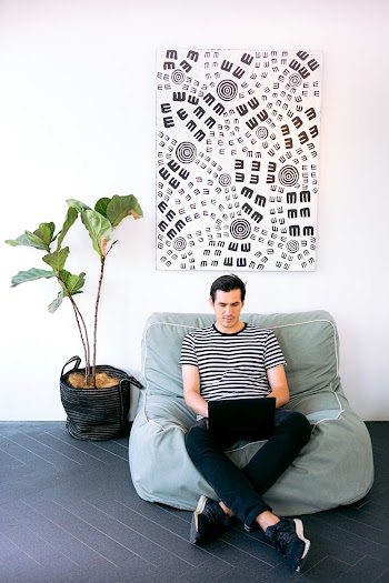 Man Sitting Cozy While Working on his Laptop