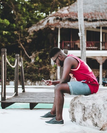 Man Sitting Down on Rock