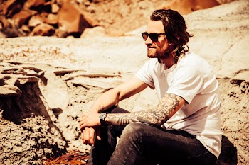 Man Sitting in Brown Stone