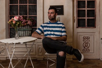 Man Sitting In Chair Facing Sideways