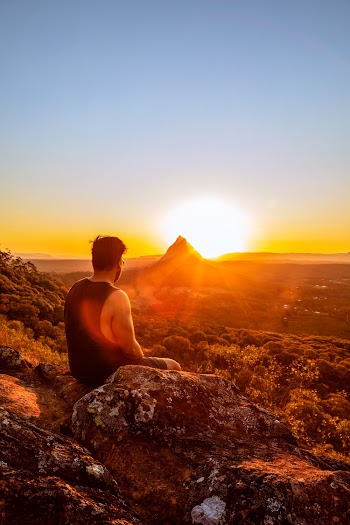 Man Sitting in Front of Mountain Views