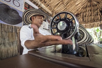 Man Sitting in Front of Sewing Machine