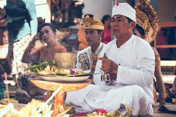 Man Sitting in Front of Woman Near Table Performing Ritual Ceremony