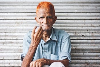 man sitting in front roll-top gate