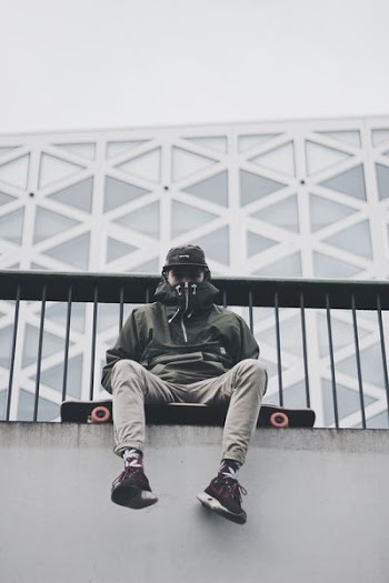 man sitting longboard