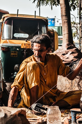 Man Sitting Near Autorickshaw