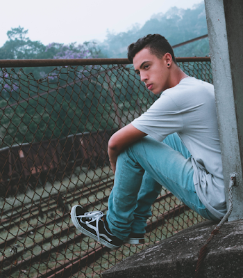 Man Sitting Near Fence