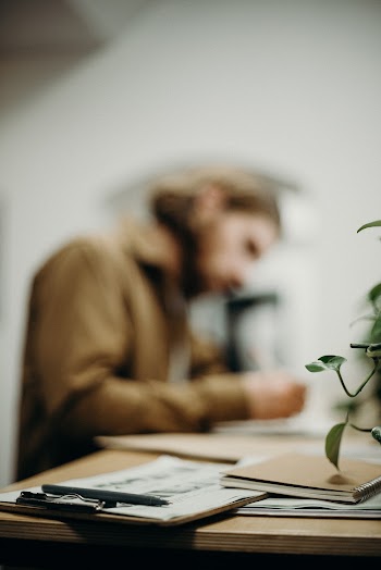Man Sitting Near His Table