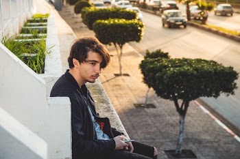 man sitting near stair