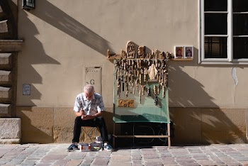 Man Sitting Near the Wall