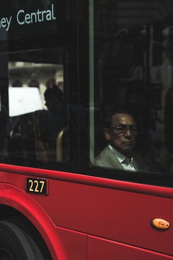 man sitting near vehicle window at daytime