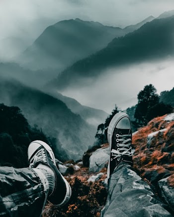 Man Sitting on a Mountain Cliff