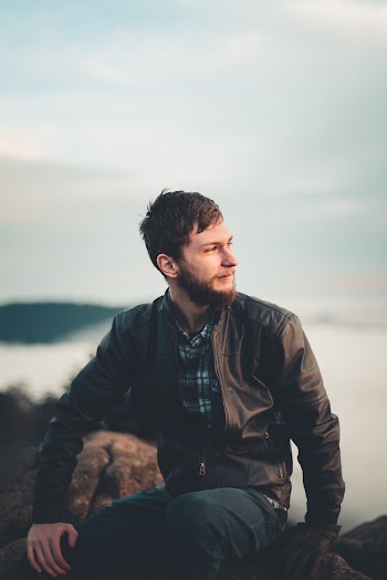 Man Sitting On A Rock