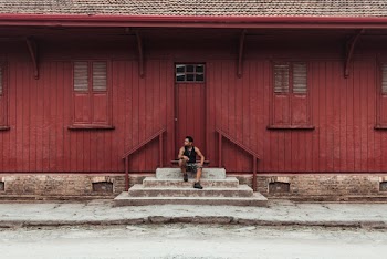 Man Sitting On A Stairway near a door
