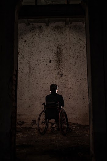 Man Sitting On A Wheelchair