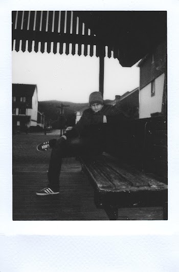 Man Sitting on a Wooden Bench