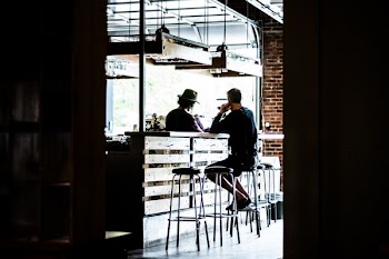 man sitting on bar stool