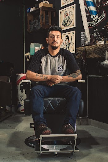 Man Sitting On Barber Chair Inside Room