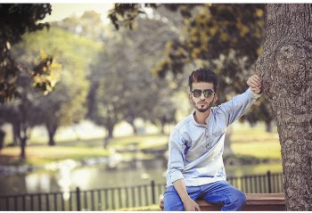 Man Sitting On Bench Beside Tree