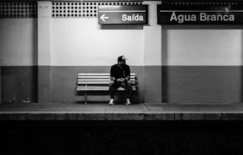 Man Sitting on Bench in Train Station