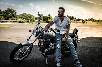 Man Sitting on Black Cruiser Motorcycle