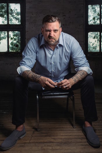 Man Sitting on Black Leather Padded Chair