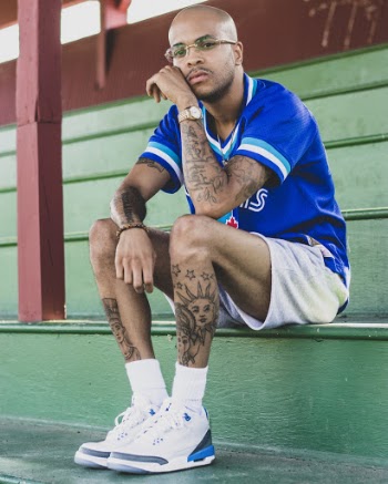 Man Sitting On Bleachers