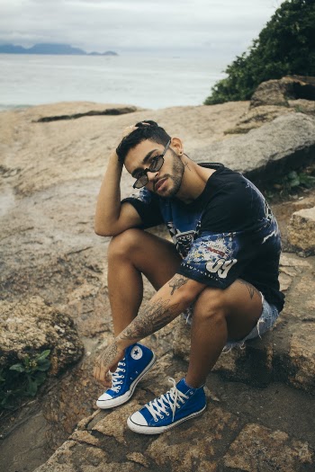 Man Sitting on Boulder