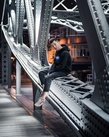 man sitting on bridge