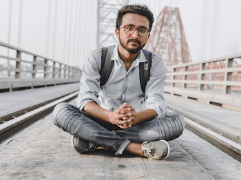 Man Sitting on Bridge