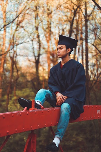 Man Sitting On Bridge
