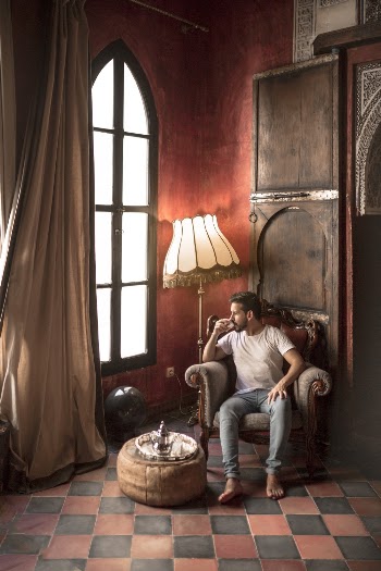 Man Sitting on Brown Armchair