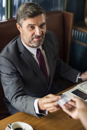 Man Sitting on Brown Chair