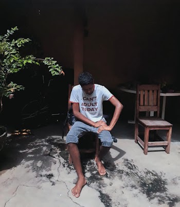 Man Sitting on Brown Chair
