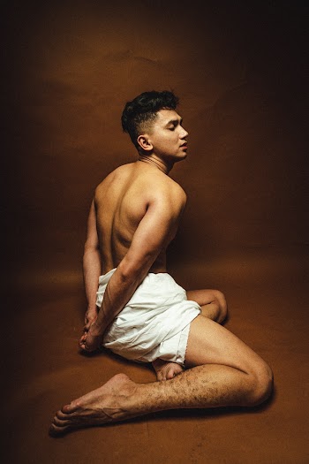 Man Sitting on Brown Floor