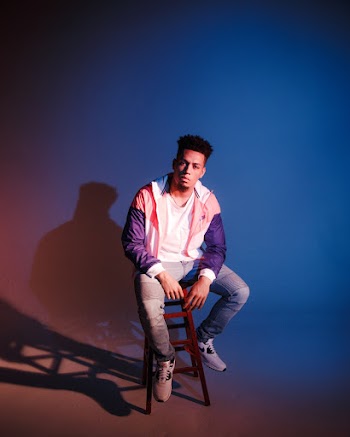 Man Sitting on Brown Stool