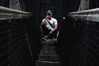 man sitting on brown surface